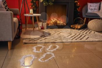 Footprints of Santa on floor in room decorated for Christmas�