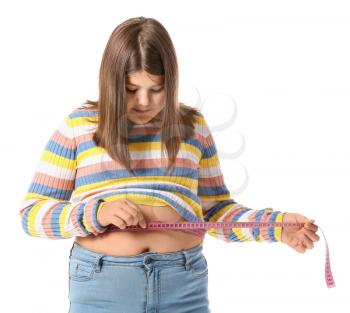 Overweight girl measuring her waist on white background�