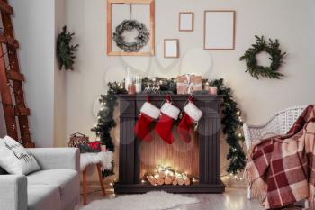 Decorated fireplace in interior of room on Christmas eve�