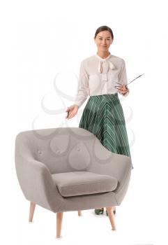 Portrait of female psychologist near armchair on white background�