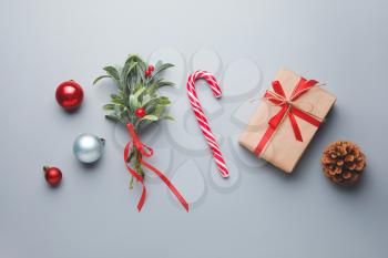 Christmas composition with mistletoe branch and decor on grey background�