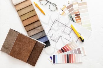 House plan, color palettes and fabric samples on light background�