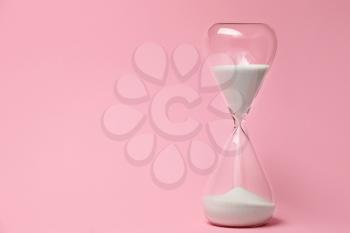 Hourglass on color background. Time management concept�