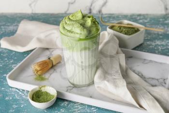 Composition with tasty dalgona matcha latte on color background�