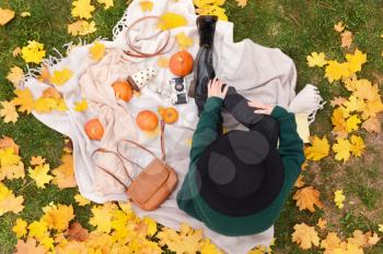 Woman resting in autumn park, top view�