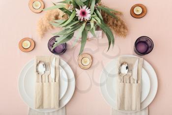 Beautiful table setting on color background�