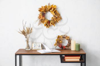 Table with autumn decor in interior of room�