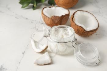 Jar with coconut oil on light background�
