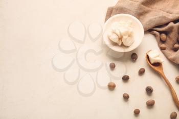 Shea butter with nuts on light background�