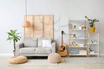 Interior of modern living room with shelf unit and sofa�