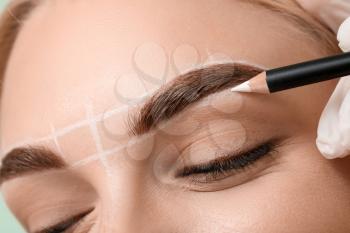 Young woman undergoing eyebrow correction procedure, closeup�