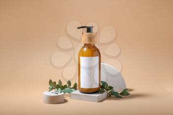 Composition with bottle of natural shampoo on color background�