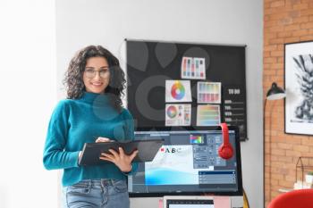 Young female designer working in office�