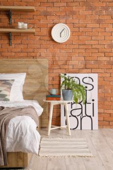 Interior of bedroom with brick wall�