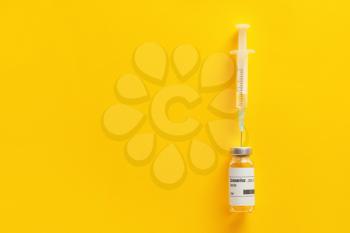 Vaccine for immunization against COVID-19 and syringe on color background�