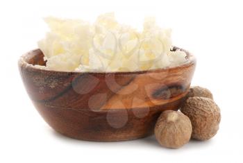 Bowl with shea butter and nuts on white background�