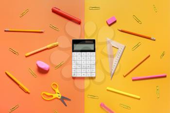Modern calculator and stationery on color background�