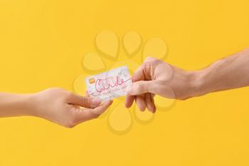 Hands with gift card on color background�