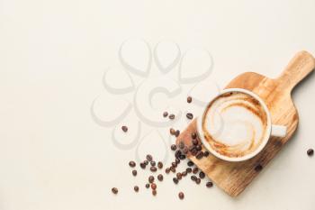 Cup of hot cappuccino on light background�