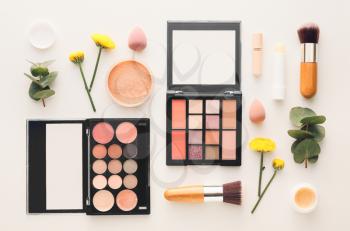 Cosmetics and flowers on white background�