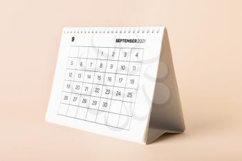 Flip calendar with page of September on color background�