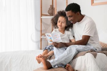 Cute African-American girl greeting her dad on Father's Day�