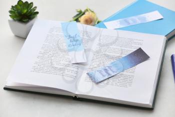 Books with bookmarks on light background�