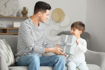 Little boy greeting his dad on Father's Day at home�