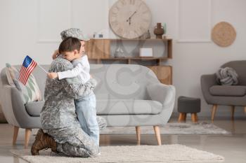 Soldier and his little son hugging at home. Memorial Day celebration�