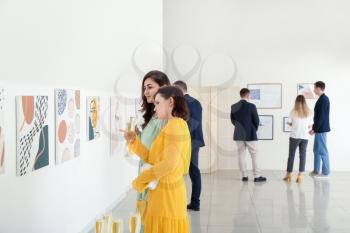 People at exhibition in modern art gallery�
