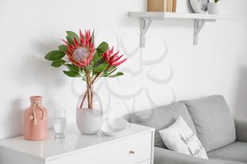 Chest of drawers with protea flowers in interior of room�