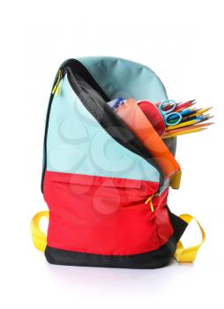 School backpack and stationery on white background�