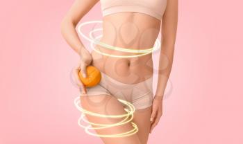 Young woman with orange fruit on color background. Concept of cellulite�