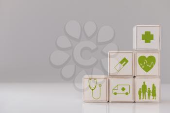 Wooden cubes on grey background. Health care insurance concept�