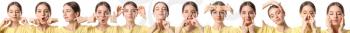 Young woman doing face building exercises against white background�