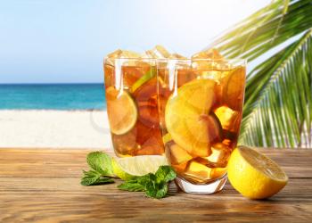 Glasses of tasty cold ice tea on table in beach bar�