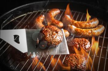 Cooking of delicious patties on barbecue grill, closeup�