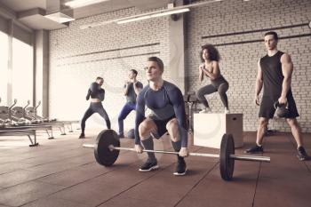 Group of athletes working out in gym�