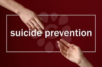 Woman giving her friend a hand against color background. Suicide prevention concept�