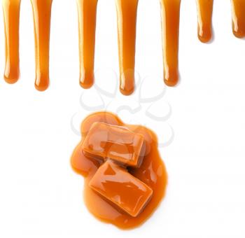Tasty caramel candies and stains on white background�