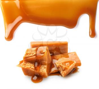 Tasty caramel candies and stains on white background�