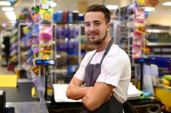 Portrait of male cashier in supermarket�