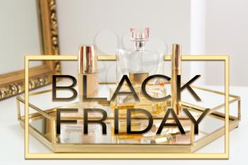 Tray with makeup cosmetics and bottles of perfumes on dressing table. Black Friday sale�