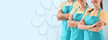 Team of janitors on color background with space for text�