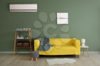 Stylish interior of living room with modern air conditioner�
