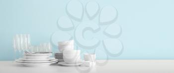Set of clean dishware on table with space for text�