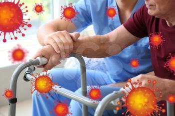 Elderly man with caregiver in nursing home. Concept of Coronavirus epidemic�