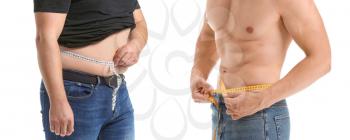 Young man measuring his waist before and after weight loss on white background�