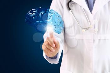 Female neurologist with digital model of brain on dark background�