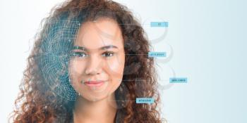 Young businesswoman using facial recognition system for data protection�